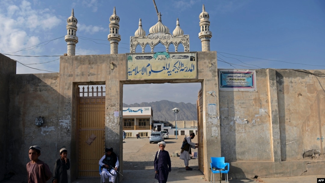 FILE - This picture taken on November 7, 2021 shows a student walking through the entrance of the Darul Uloom Hakimia madrassa where the Taliban Supreme Leader Hibatullah Akhundzada reportedly appeared, in Kandahar province.