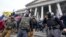FILE - Members of the Oath Keepers on the East Front of the U.S. Capitol on Jan. 6, 2021, in Washington.