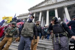 FILE - Members of the Oath Keepers on the East Front of the U.S. Capitol on Jan. 6, 2021, in Washington.