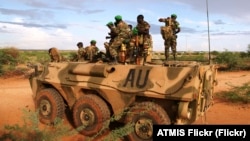 FILE — Troops belonging to the African Union stand on top of an APC on the outskirts of Burubow in Somalia's Gedo region, Feb.14, 2014.