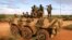 FILE — Troops belonging to the African Union stand on top of an APC on the outskirts of Burubow in Somalia's Gedo region, Feb.14, 2014.