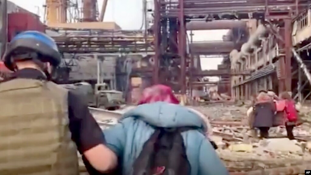 This frame taken from an undated video provided Sunday, May 1, 2022 by the Azov Special Forces Regiment of the Ukrainian National Guard shows people walking over debris at the Azovstal steel plant, in Mariupol, eastern Ukraine. (Azov Special Forces Regiment Handout via AP)