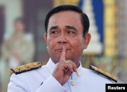 Thailand's Prime Minister Prayuth Chan-ocha reacts while taking questions from journalists after the group photo session with new government cabinet in Bangkok, Thailand July 16, 2019. REUTERS/Soe Zeya Tun