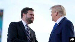 Senate candidate JD Vance, left, greets former President Donald Trump at a rally at the Delaware County Fairground, April 23, 2022, in Delaware, Ohio, to endorse Republican candidates ahead of the Ohio primary on May 3.