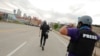 FILE - AP photojournalists John Minchillo and Julio Cortez cover continued demonstrations in reaction to the death in Minneapolis police custody of George Floyd, in Minneapolis, Minn., May 31, 2020.