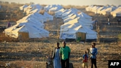 FILE - Ethiopian refugees walk together early in the morning on Coptic Christmas day at Um Raquba refugee camp in Gedaref, eastern Sudan, on January 7, 2021.