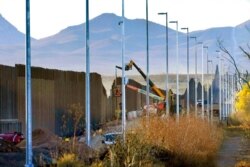 FILE - Crews construct a section of border wall in San Bernardino National Wildlife Refuge in Douglas, Ariz., Dec. 8, 2020.