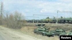 A still image from video shows tanks and military vehicles in Maslovka, Voronezh Region, Russia April 6, 2021. 
