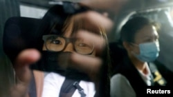 FILE - Chow Hang-tung is seen inside a vehicle after being detained in Hong Kong, Sept. 8, 2021.