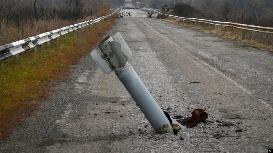 A tail of a rocket sticks out of the ground near the recently recaptured village of Zakitne, Ukraine, Nov. 9, 2022. 