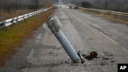 A tail of a rocket sticks out of the ground near the recently recaptured village of Zakitne, Ukraine, Nov. 9, 2022. 