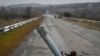 A tail of a rocket sticks out of the ground near the recently recaptured village of Zakitne, Ukraine, Nov. 9, 2022. 