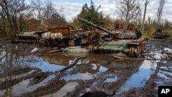 FILE: Russian tanks damaged in recent fighting are seen near the recently retaken village of Kamianka, Kharkiv region, Ukraine, Sunday, Oct. 30, 2022.