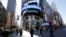 People walk past the Nasdaq MarketSite in New York, April 5, 2016.