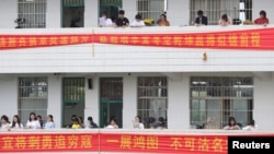 Students study along corridors at a high school ahead of the annual national college entrance examination, in Hengyang, Hunan province, China, June 3, 2018. In nearby Leiyang, parents protested a plan to move students from overcrowded schools. Parents were concerned about formaldehyde in the dormitory.