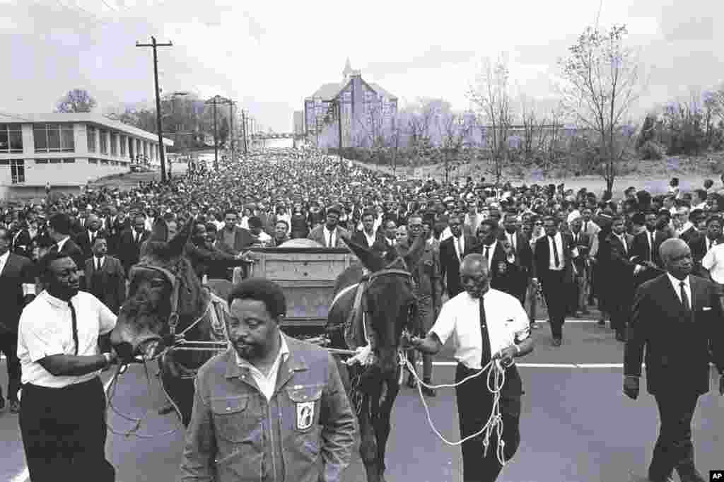 This April 1968 photo released by the MLK Jr. National Historic Site shows the body of Martin Luther King Jr. being carried to Morehouse College in Atlanta, Georgia. (AP Photo/MLK Jr. National Historic Site,Courtesy of Bob Adelman)