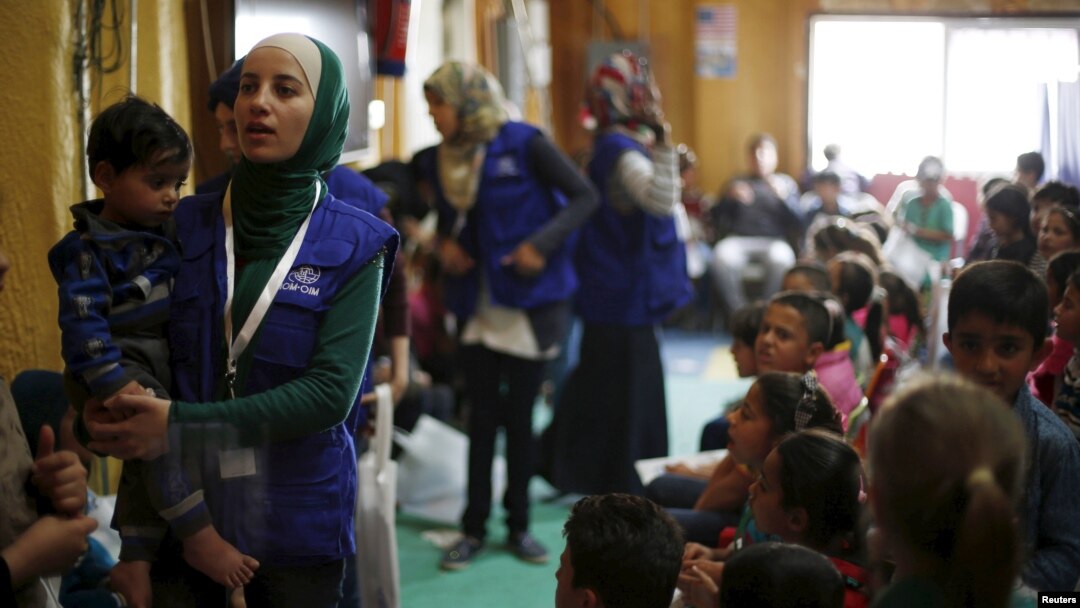 FILE - Syrian refugee children play as they wait with their families to register their information at the U.S. processing center for Syrian refugees in Jordan, in Amman, Jordan, April 6, 2016.