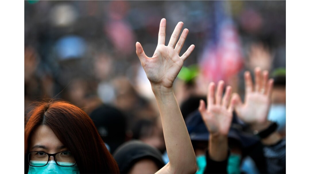 Pro-democracy protesters raise their hands to symbolize the five demands of the pro-democracy movement during a rally in Hong Kong, Dec. 1, 2019.