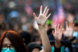 Pro-democracy protesters raise their hands to symbolize the five demands of the pro-democracy movement during a rally in Hong Kong, Dec. 1, 2019.