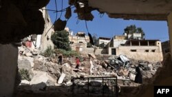 People check the destruction in the aftermath of an Israeli military raid in Qabatiyah south of Jenin in the occupied West Bank, on Sept. 20, 2024.