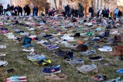 In this display in Washington, empty pairs of shoes - symbolizing the children killed by guns in the United States since the Sandy Hook shootings in 2012 - sit on the southeast lawn of the U.S. Capitol, March 13, 2018.