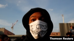 A protester wearing a protective mask attends a banned demonstration planned in memory of Adama Traore, a 24-year-old black Frenchman who died in a 2016 police operation, in front of courthouse in Paris, France June 2, 2020. . 