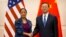 U.S. National Security Adviser Susan Rice, left, and Chinese State Councilor Yang Jiechi, right, shake hands as they pose for a photo at the Diaoyutai State Guesthouse in Beijing, Monday, July 25, 2016.