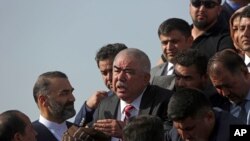 FILE - Gen. Abdul Rashid Dostum, center, and members of his entourage disembark on arrival at Kabul International Airport in Kabul, Afghanistan, July 22, 2018. 