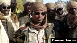 FILE - The son of Chad's late president Idriss Deby, Mahamat Idriss Deby Itno (also known as Mahamat Kaka) and Chadian army officers gather in the northeastern town of Kidal, Mali, Feb. 7, 2013.