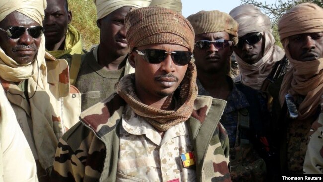 FILE - Mahamat Idriss Deby Itno and Chadian army officers gather in the northeastern town of Kidal.