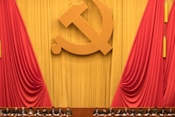 FILE - In this Oct. 18, 2017, photo, Chinese communists party cadres attend the opening ceremony of the 19th Party Congress held at the Great Hall of the People in Beijing, China.