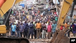 FILE—Residents watch as excavators and bulldozers bring down their homes in the Mathare area of Nairobi, May 8, 2024. 