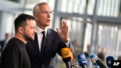 NATO Secretary General Jens Stoltenberg, right, and Ukraine's President Volodymyr Zelenskyy address a media conference prior to a meeting of NATO defense ministers at NATO headquarters in Brussels, Wednesday, Oct. 11, 2023. 