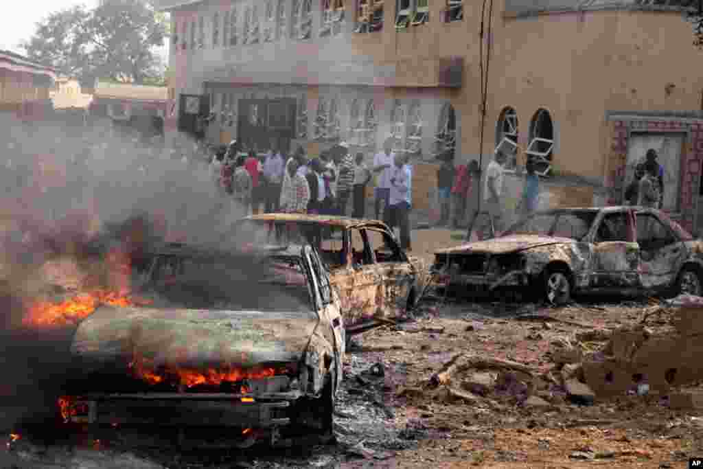 A car burns at the scene of a bomb explosion at St. Theresa Catholic Church. (Reuters)