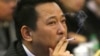 FILE - Liu Han, former chairman of Hanlong Mining, smokes a cigarette during a conference in Mianyang, Sichuan province.