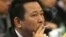 FILE - Liu Han, former chairman of Hanlong Mining, smokes a cigarette during a conference in Mianyang, Sichuan province.