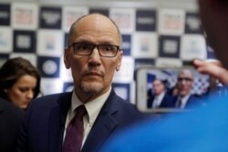 FILE- Democratic National Committee chairman Tom Perez is recorded on a phone before a Democratic presidential primary debate in Los Angeles, Calif., Dec. 19, 2019.