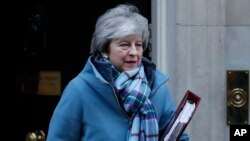 Britain's PM Theresa May leaving 10 Downing Street, Jan. 30, 2019. May is gathering pro-Brexit and pro-EU Conservative lawmakers into an "alternative arrangements working group" seeking to break Britain's Brexit deadlock.