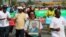 FILE - A woman holds up a picture of Burundi's President Pierre Nkurunziza during a rally in Bujumbura on May 14, 2016, commemorating the one-year anniversary of the failed attempt of a government coup. 