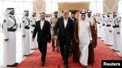 Iranian President Masoud Pezeshkian is welcomed by Qatari officials upon his arrival at Doha's airport, in Doha, Qatar, Oct. 2, 2024. (Iran's Presidency/WANA/Handout via Reuters)