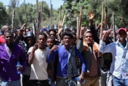 Oromo youth chant slogans during a protest in-front of Jawar Mohammed's house, an Oromo activist and leader of the Oromo protest in Addis Ababa, Ethiopia, Oct. 24, 2019.