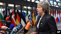 FILE - British Prime Minister Theresa May speaks with the media.