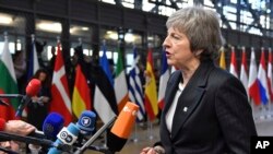 FILE - British Prime Minister Theresa May speaks with the media.