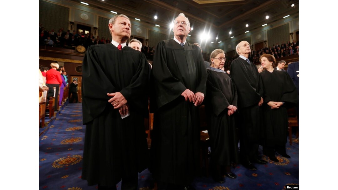 FILE -- U.S. Supreme Court Chief Justice John Roberts (L) stands with fellow Justices Anthony Kennedy (2nd from L), Ruth Bader Ginsburg, Stephen Breyer and Elena Kagan (R) on Capitol Hill in Washington.