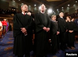 FILE -- U.S. Supreme Court Chief Justice John Roberts (L) stands with fellow Justices Anthony Kennedy (2nd from L), Ruth Bader Ginsburg, Stephen Breyer and Elena Kagan (R) on Capitol Hill in Washington.
