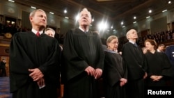 FILE - U.S. Supreme Court Chief Justice John Roberts (L) stands with fellow Justices Anthony Kennedy (2nd from L), Ruth Bader Ginsburg, Stephen Breyer and Elena Kagan (R) prior to President Barack Obama's State of the Union speech on Capitol Hill in Washington. The Supreme Court is set to decide a number of ideologically charged cases in 2016 on topics such as abortion, contraceptives, immigration and union membership.