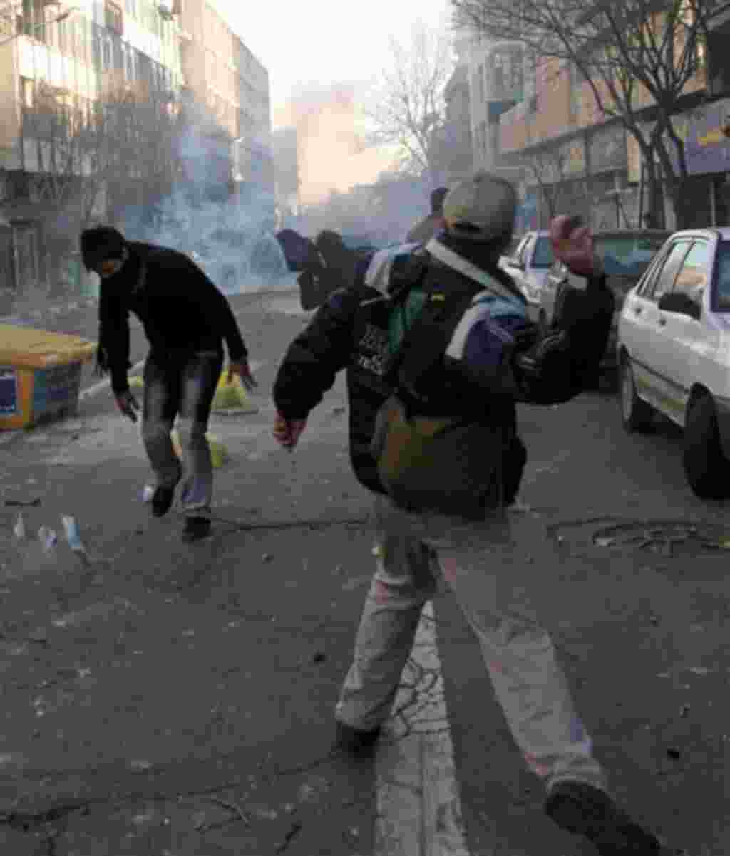 This photo, taken by an individual not employed by the Associated Press and obtained by the AP outside Iran shows Iranian protestors throwing stones at ant-riot police officers, during an anti-government protest in Tehran, Iran, Monday, Feb. 14, 2011. Eye