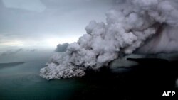 This aerial picture taken on Dec. 23, 2018 by Bisnis Indonesia shows the Anak (Child) Krakatoa volcano erupting in the Sunda Straits off the coast of southern Sumatra and the western tip of Java. 
