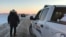 FILE - This photo released Jan. 20, 2022, by the Royal Canadian Mounted Police in Emerson, Manitoba, shows RCMP officers near the Canada-US border. Canada and the U.S. have agreed to trace guns that are intercepted at the border. (RCMP/AFP)