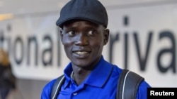 Marathon runner Guor Marial arrives at Heathrow Airport for the London 2012 Olympic Games, August 3, 2012. 